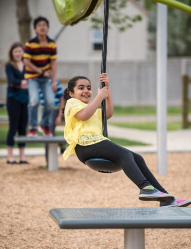 girl using track ride swing