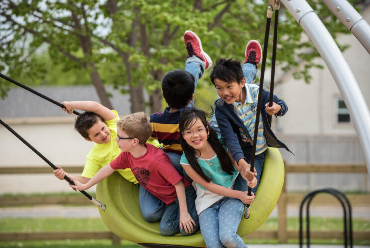 5 kids on large green swing