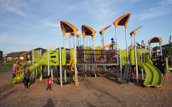 kids playing on green playground structure at Norseman Park