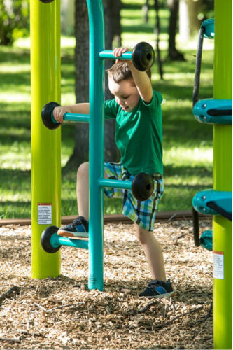 young boy climbing up teal ladder