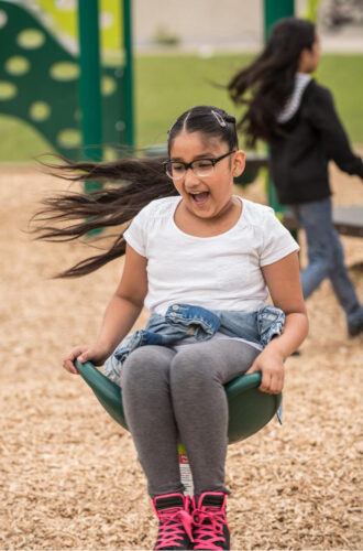 Girl playing on saddle spinner