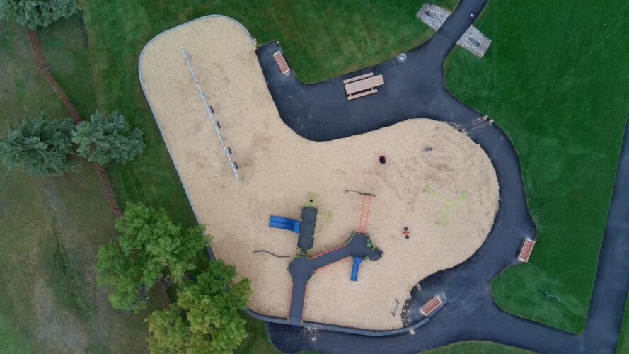 Birds-eye view of playground safety surfacing and equipment at Andrew Mynarski VC Park.