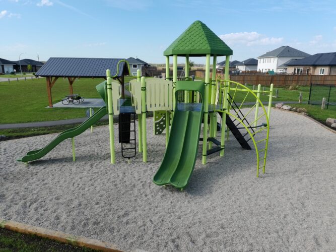 Play structure featuring 3 slides and climbing features at Amberfield Park.