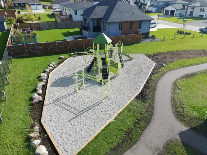 Playground structure at Amberfield Park, surrounded by houses in the neighborhood.