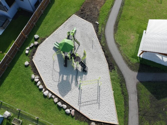Overhead view of Amberfield Park's playground structure surrounded by play area landscaping.