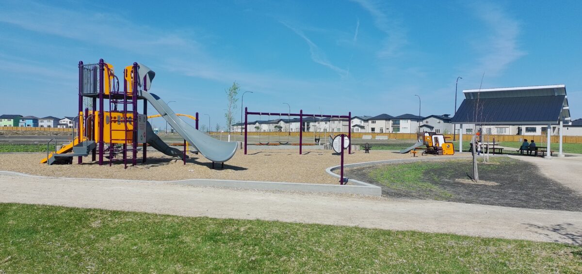 Playground featuring a slides, climbers, swings and a shelter at Firestone Park