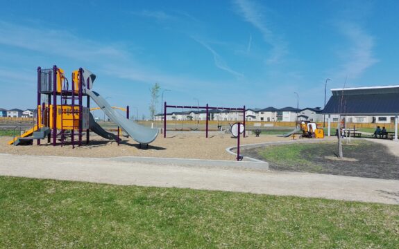 Playground featuring a slides, climbers, swings and a shelter at Firestone Park