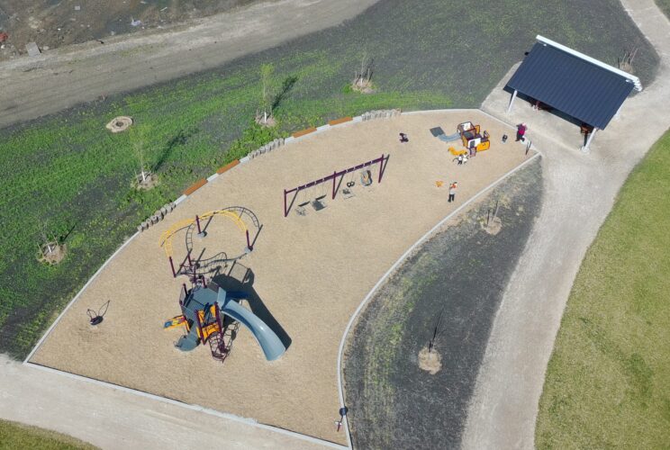 Top view looking down on the playground, swings and shelter at Firestone Park