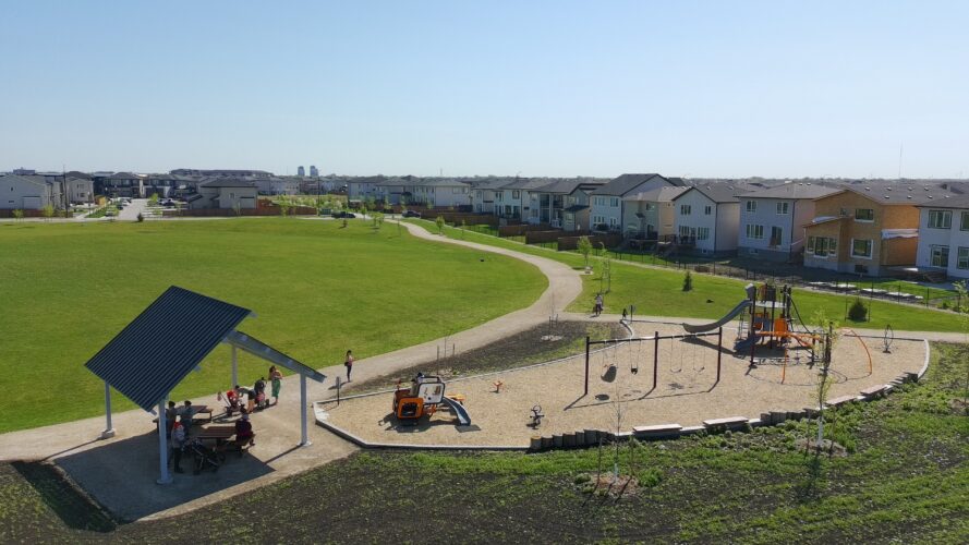 Side view overlooking the play equipment, shelter and swings at Firestone Park